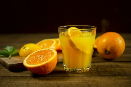 orange juice in clear drinking glass